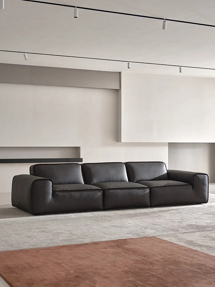Sun shinning on the black leather of the sofa
