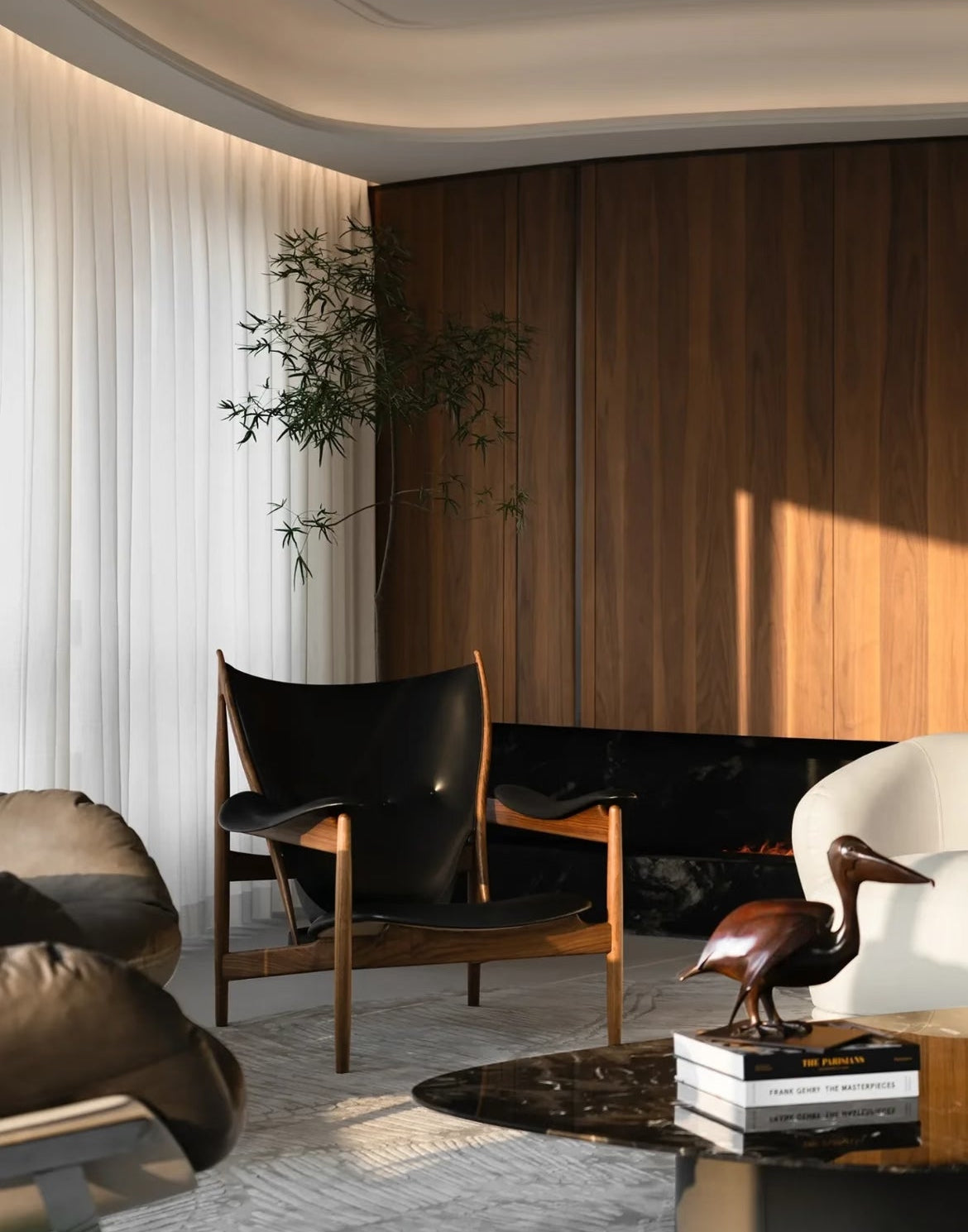 A modern living room corner featuring a mid-century style black leather and wood armchair, a white curved sofa, a dark wood-paneled wall, and a fireplace.