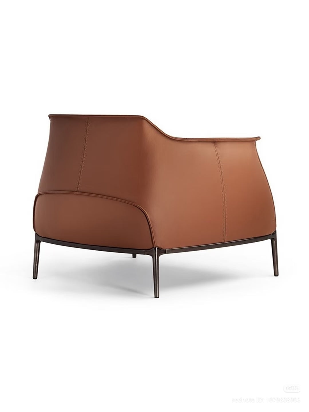 A modern brown plume armchair with a sculptural curved backrest and slim dark metal legs