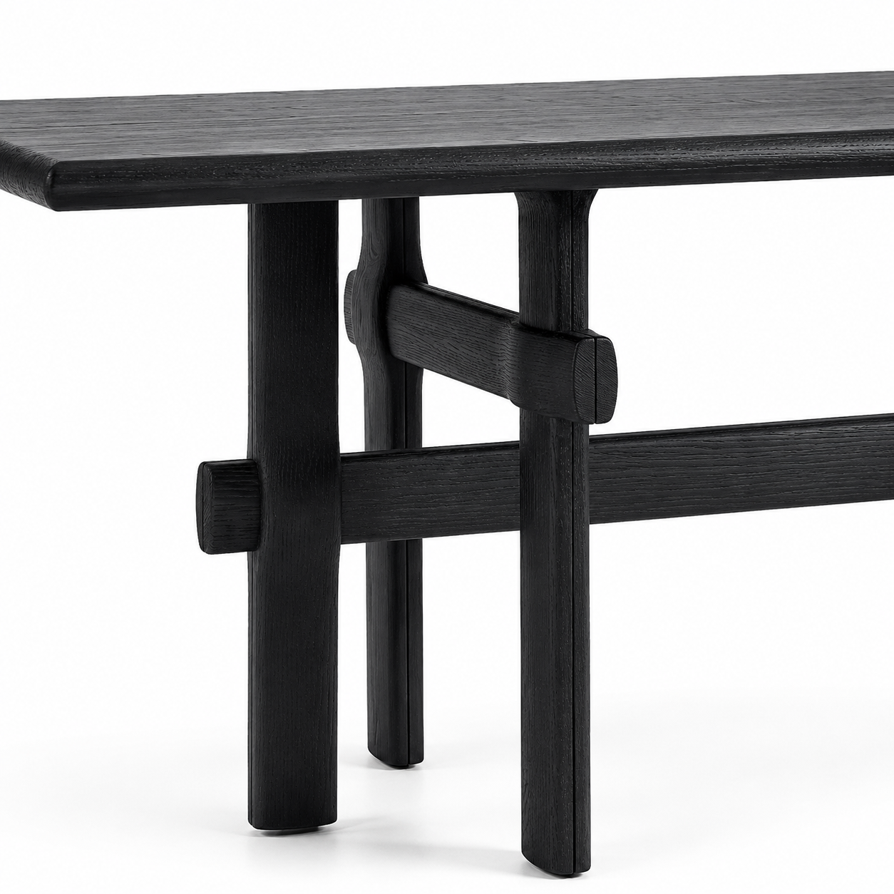 Black wooden table leg close up with a minimalist design on a white background