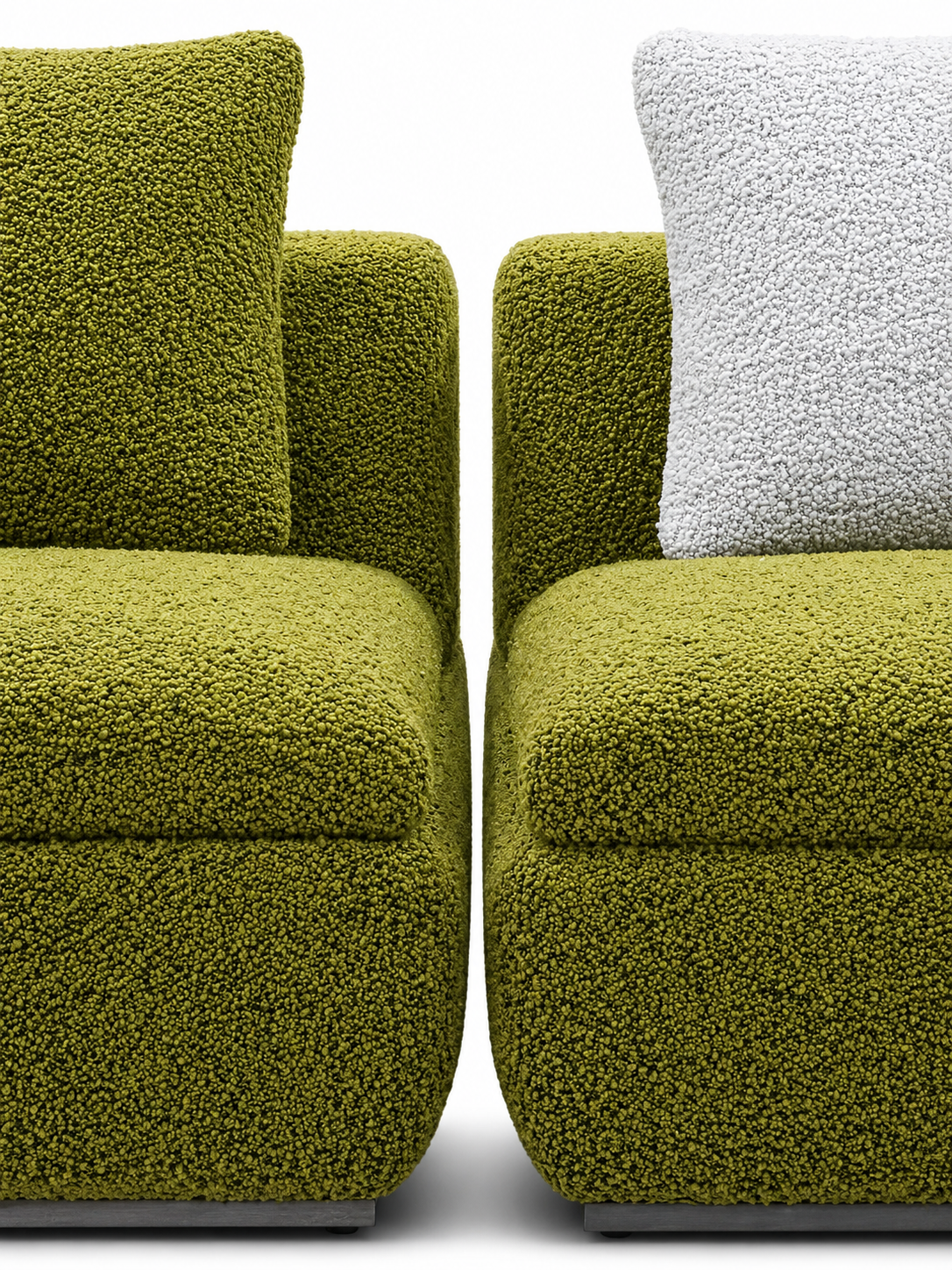 Close up side by side of two Noctures; upholstered in textured olive green boucle fabric, one with a back and the other a white cushion, shown against a plain white background.
