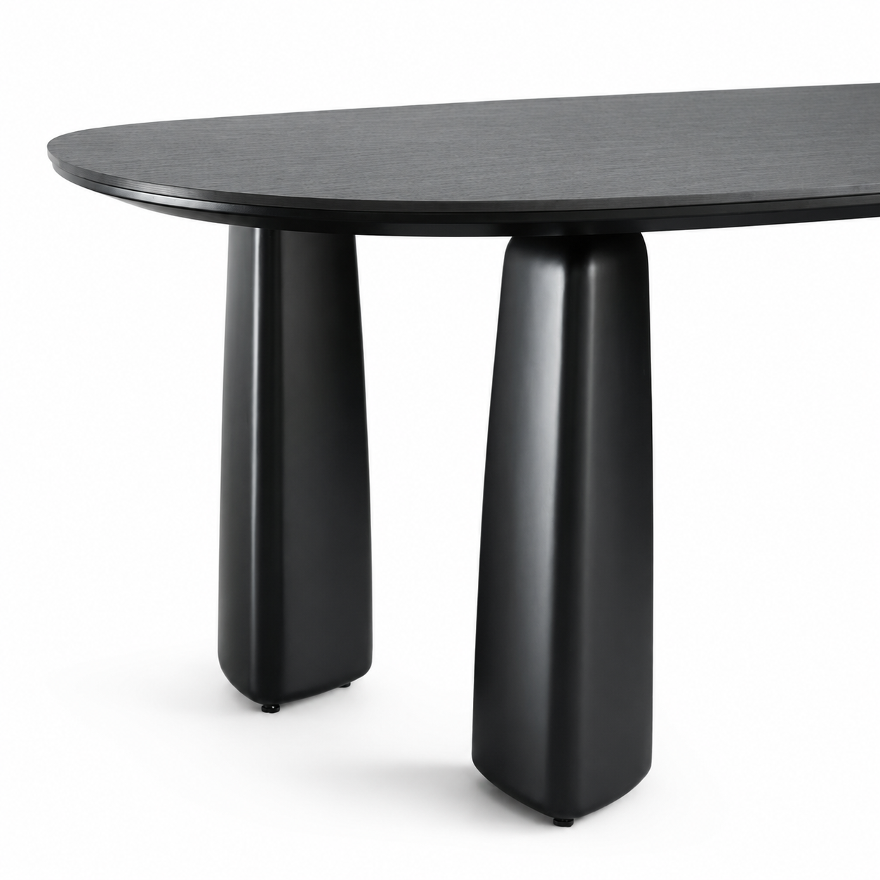 The Oris oval dining table with a dark charcoal wood grain top and two thick, tapered black pedestal legs, shown against a plain white background.