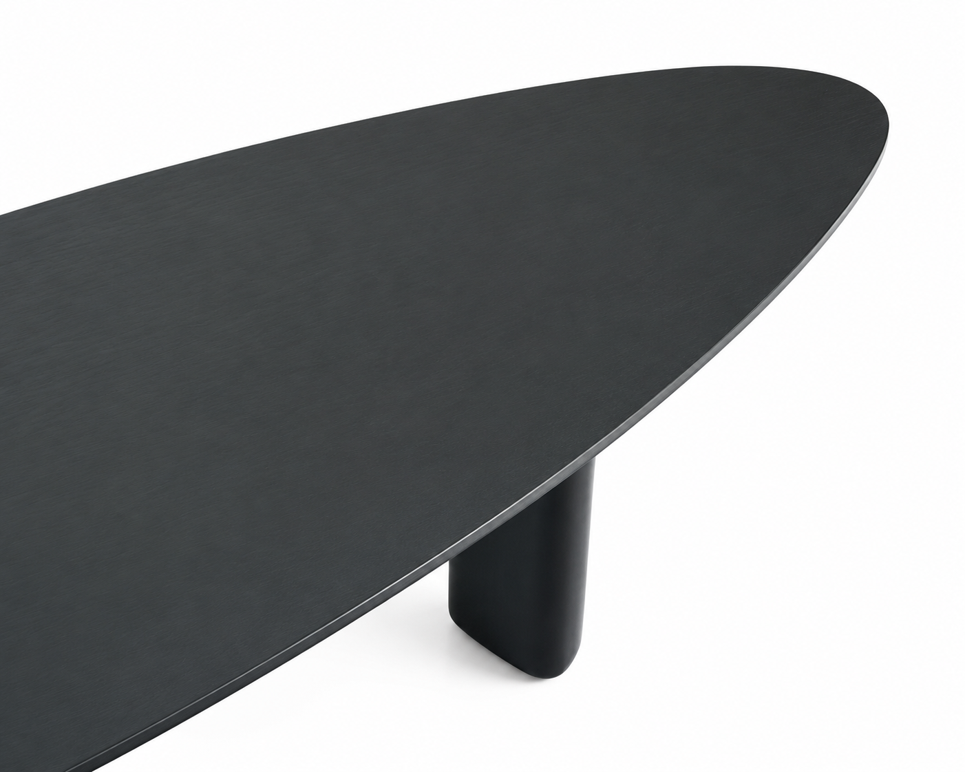 A close-up studio shot of a modern oval table with a matte black finish and a cylindrical black pedestal leg, set against a solid white background.