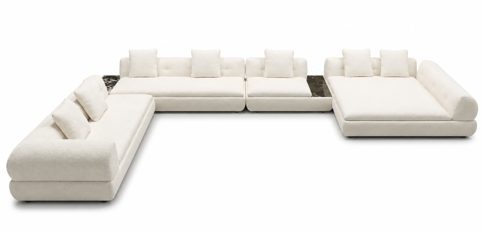 A modern modular sectional sofa in off-white upholstered fabric, featuring a left armchair, a central chaise lounge with matching pillows, and a right armchair, arranged in an L-shape on a plain white background.