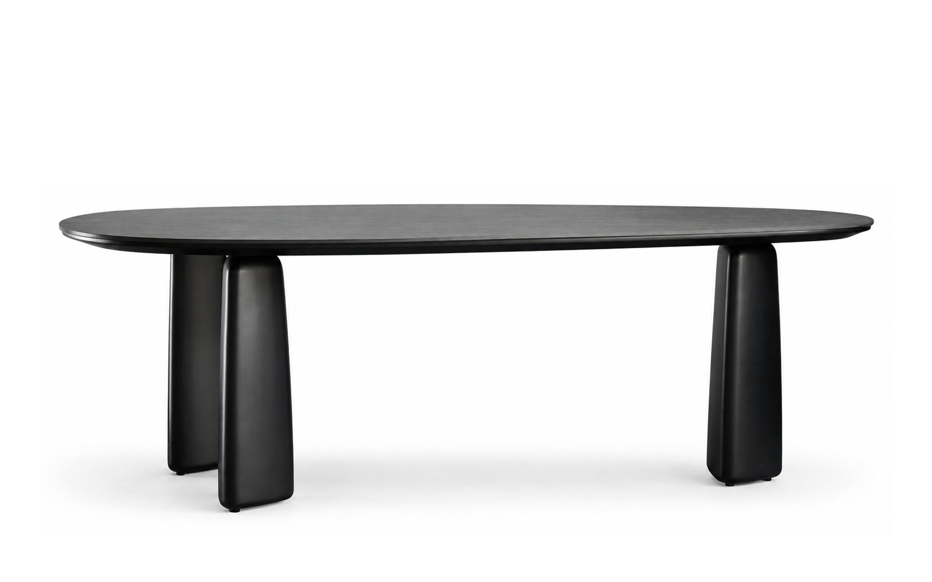Black sintered stone dining table with elongated oval top and rounded lacquered pedestal legs
